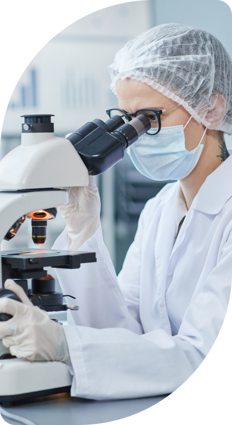 Scientist using a microscope in a lab